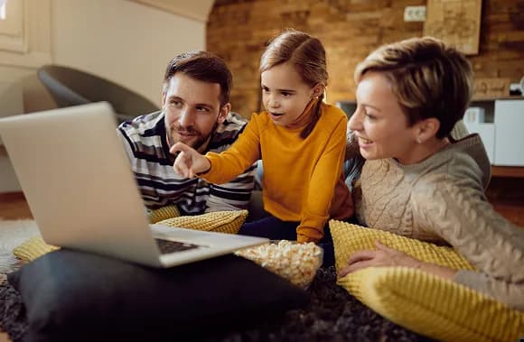 Family looking at a laptop